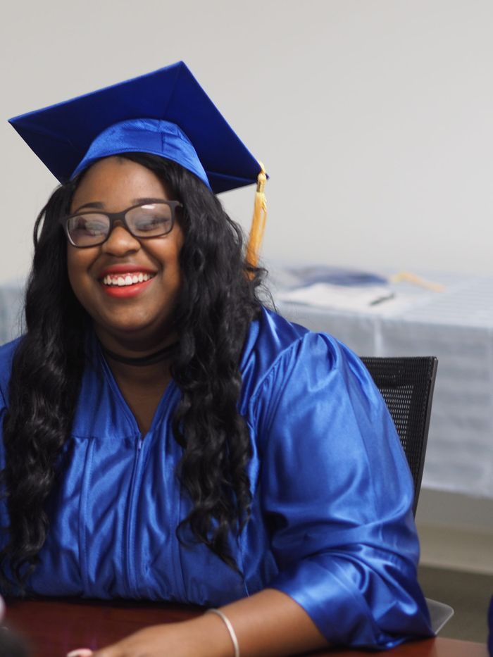 A LifePoint Career Institute graduate in cap and gown on her graduation day.