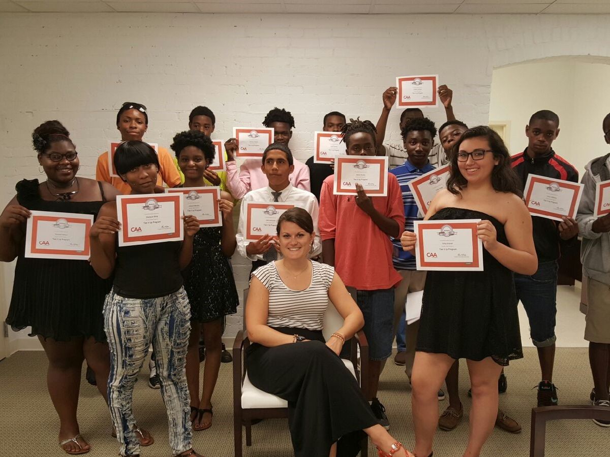 A group of students holding up their completion certificates.