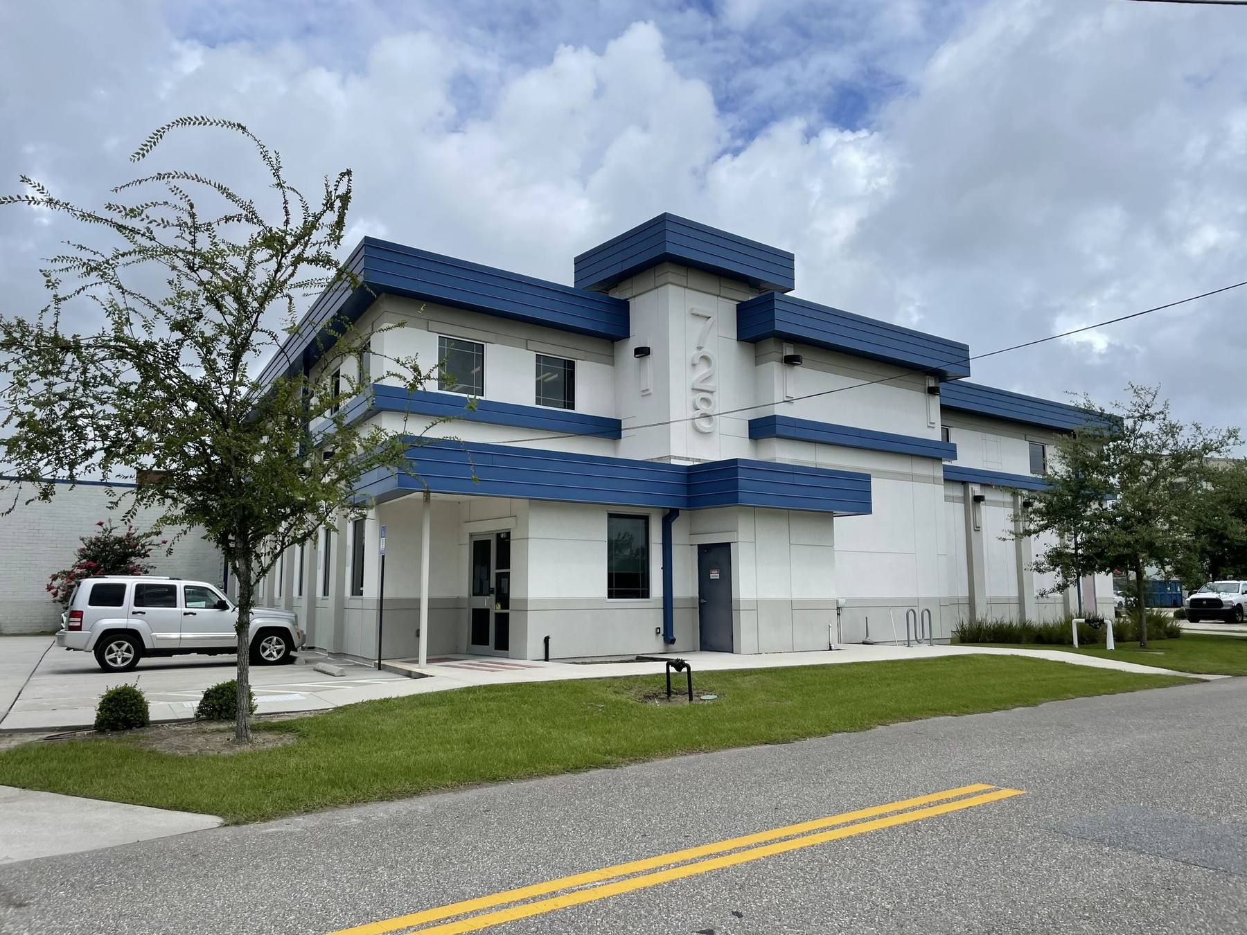 The Beaver Street Enterprise Center: a two-storey white building trimmed in deep blue, on its corner lot in northwest Jacksonville.