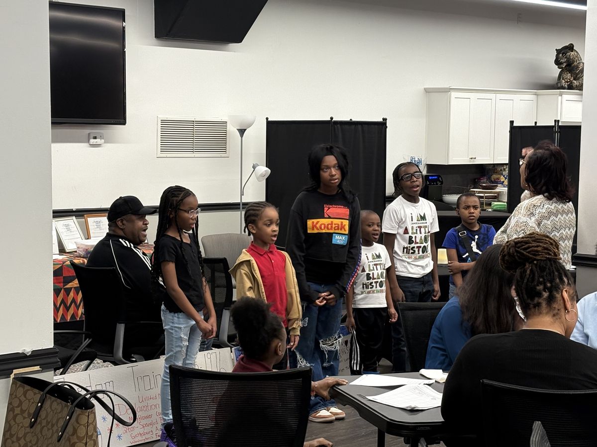 Young people presenting at a celebration at the Weaver Center