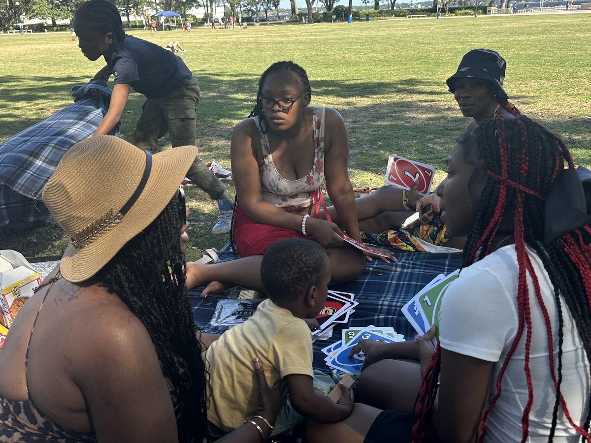 A family sharing a meal together at a FreshFamilies outdoor gathering
