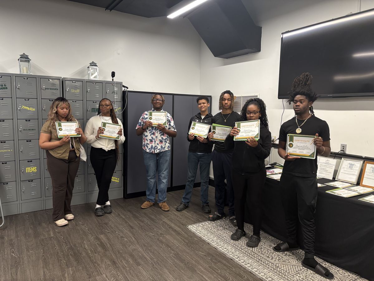 Young adults with the certificates they earned at the Weaver Center