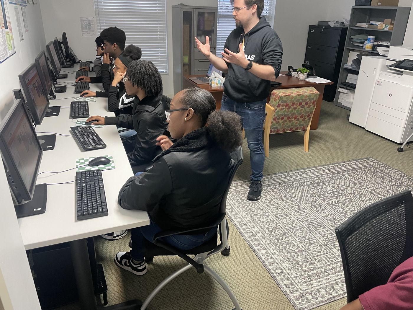 An instructor working through a lesson with students in the Weaver Center computer lab