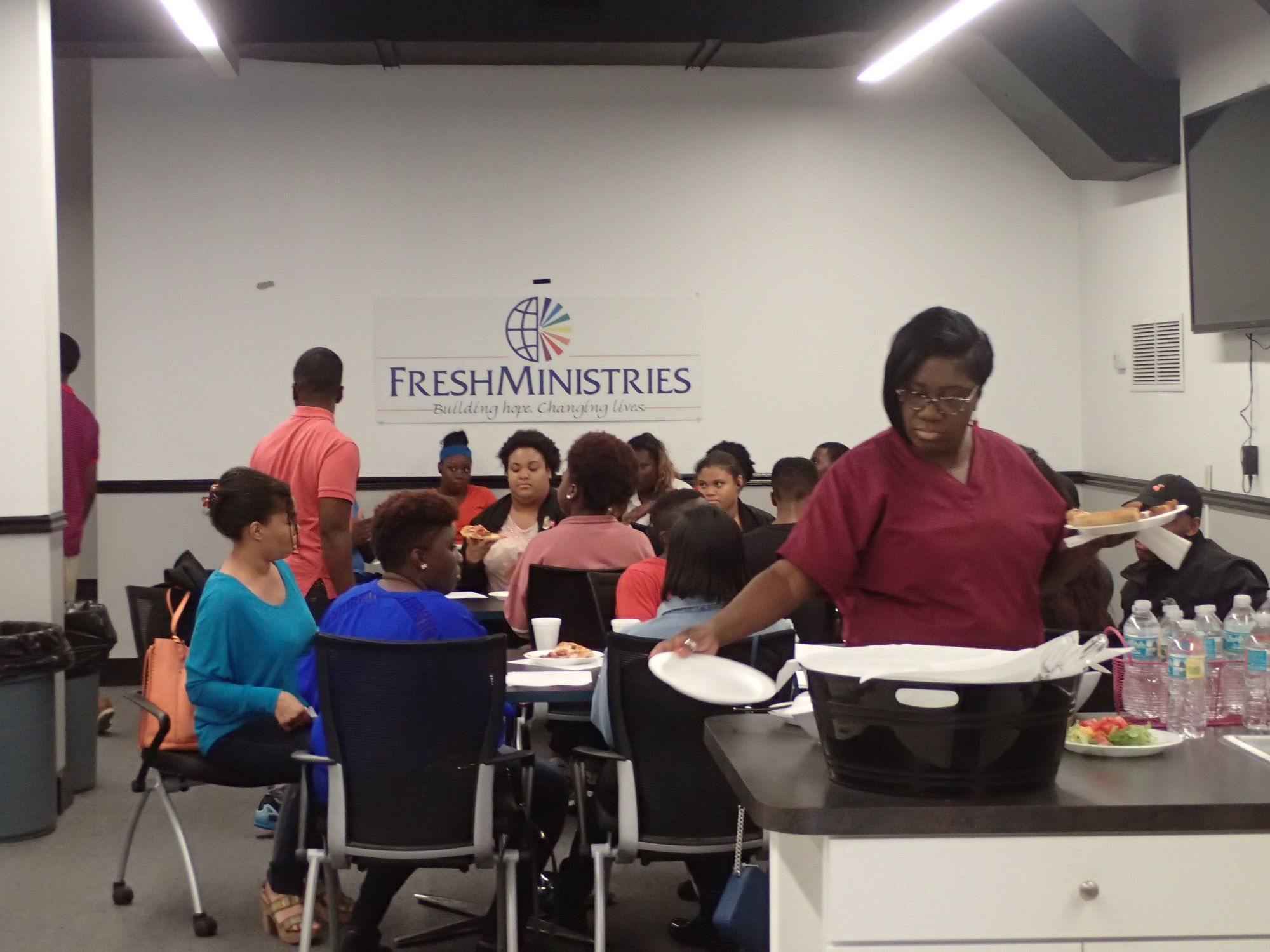 Young people and FreshMinistries staff seated around tables at a FreshFutures session in Jacksonville.