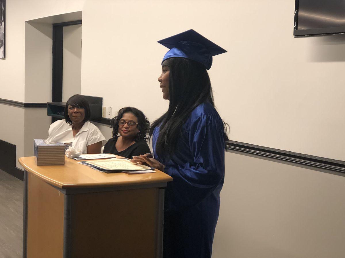 A LifePoint graduate speaking at the podium