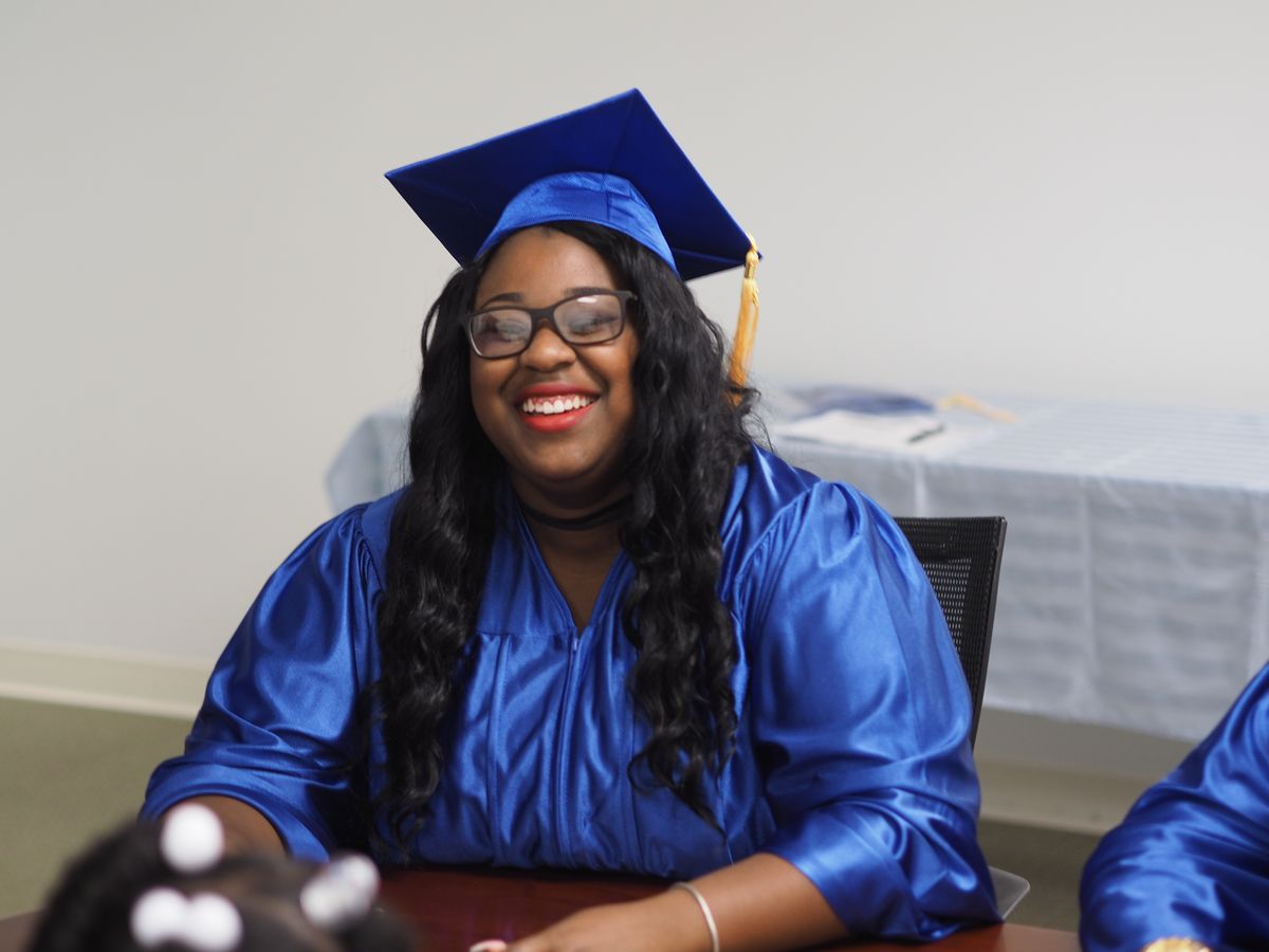 A LifePoint graduate in her cap and gown