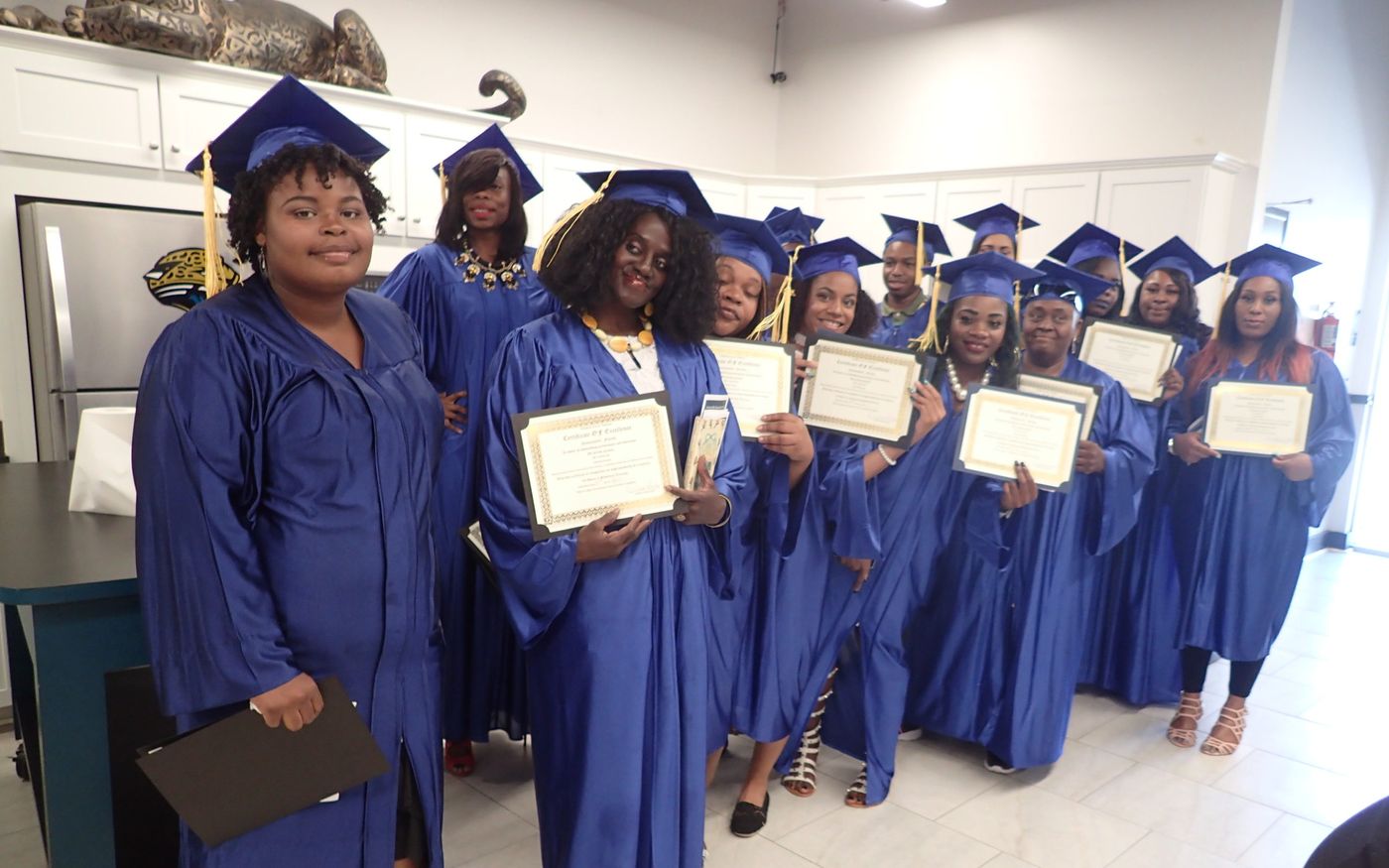 FreshMinistries graduates holding their certificates after a ceremony.